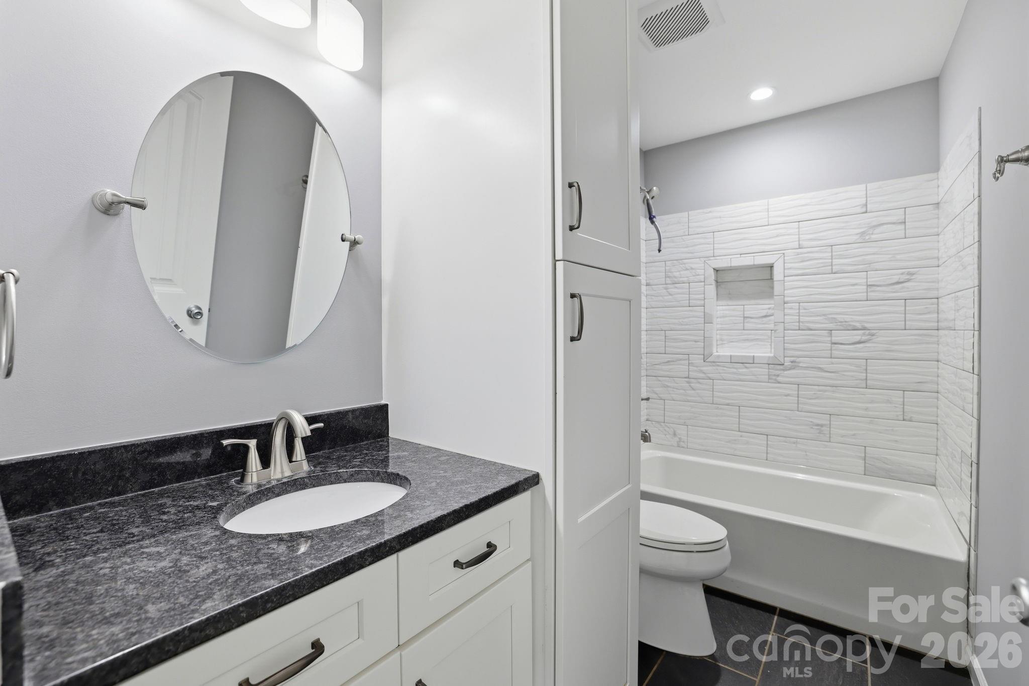 1108 Willoughby Road Monroe, NC 28110 - Photo 6 of 48 a bathroom with a granite countertop sink toilet and shower