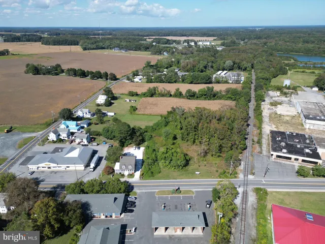 an aerial view of ocean with residential house with outdoor space and river