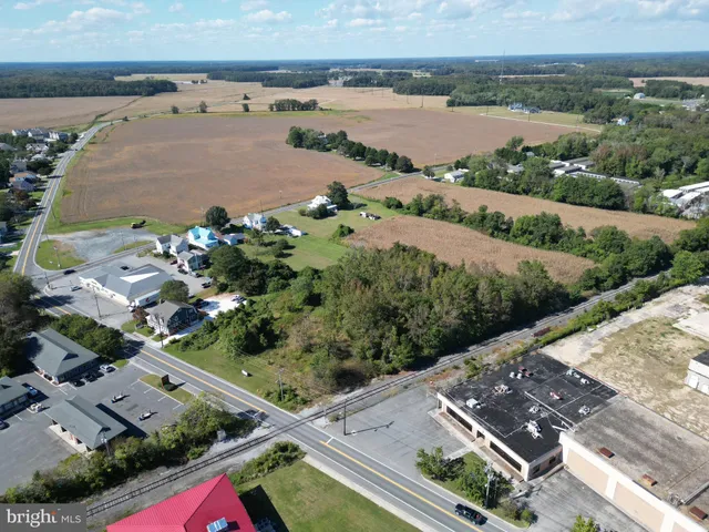 an aerial view of house with yard and ocean view