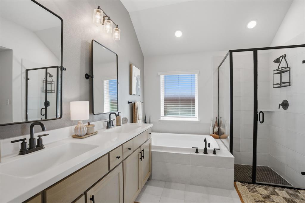 1632 Cotton Road Van Alstyne, TX 75495 - Photo 19 of 40 a bathroom with a double vanity sink tub double and mirror