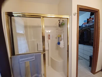 a bathroom with a glass shower door