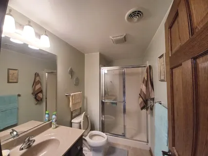 a bathroom with a sink toilet and shower