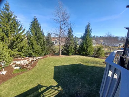 a view of a porch with furniture and a yard