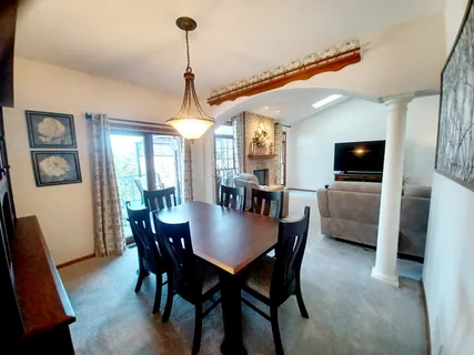 a dining room with furniture and window
