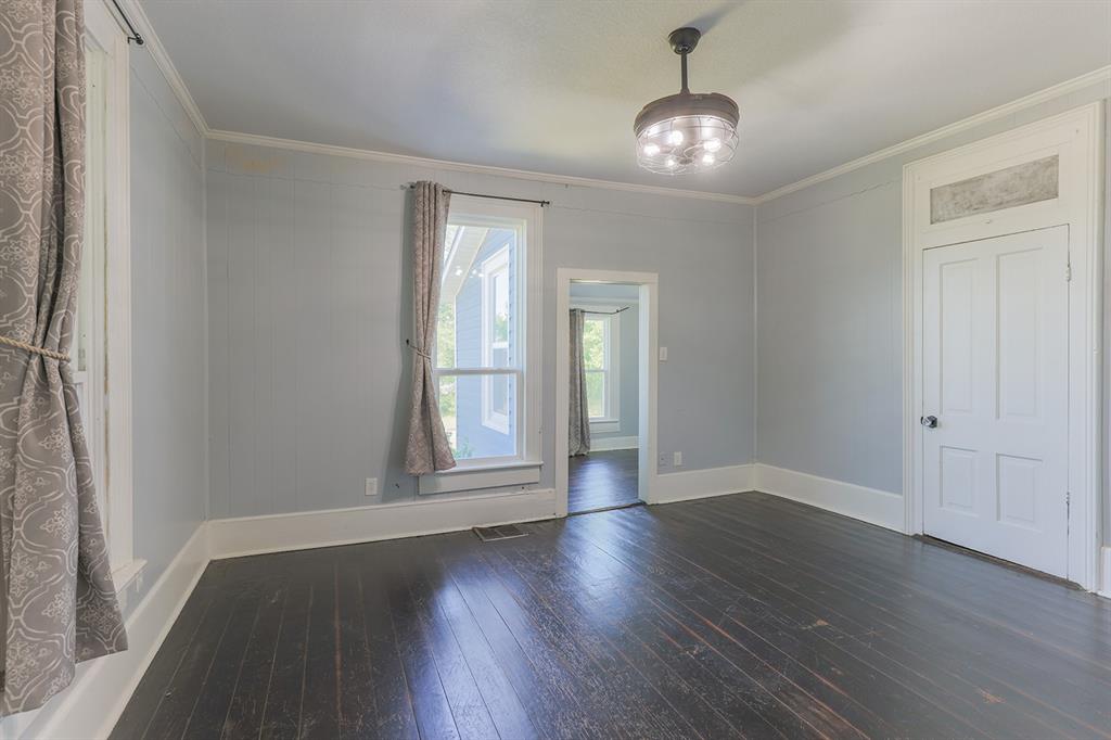 453 East Marshall Street Van Alstyne, TX 75495 - Photo 10 of 30 an empty room with wooden floor and windows