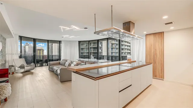 a kitchen with kitchen island white cabinets and stainless steel appliances