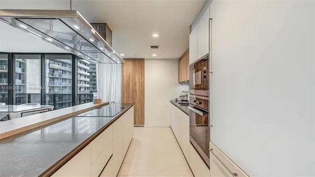 a kitchen with stainless steel appliances a sink and cabinets