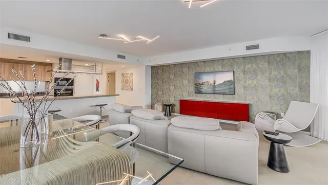 a bedroom with a bed and a potted plant on the dresser