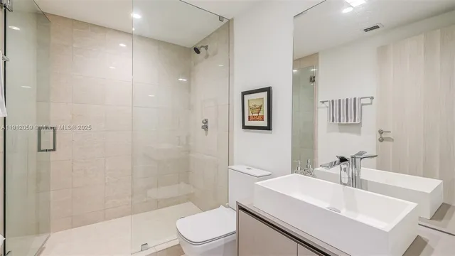 a bedroom with a large bed and a large window