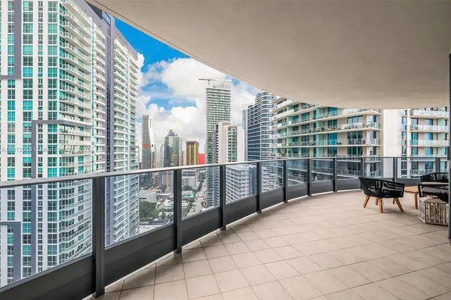 a view of a balcony with wooden floor and windows