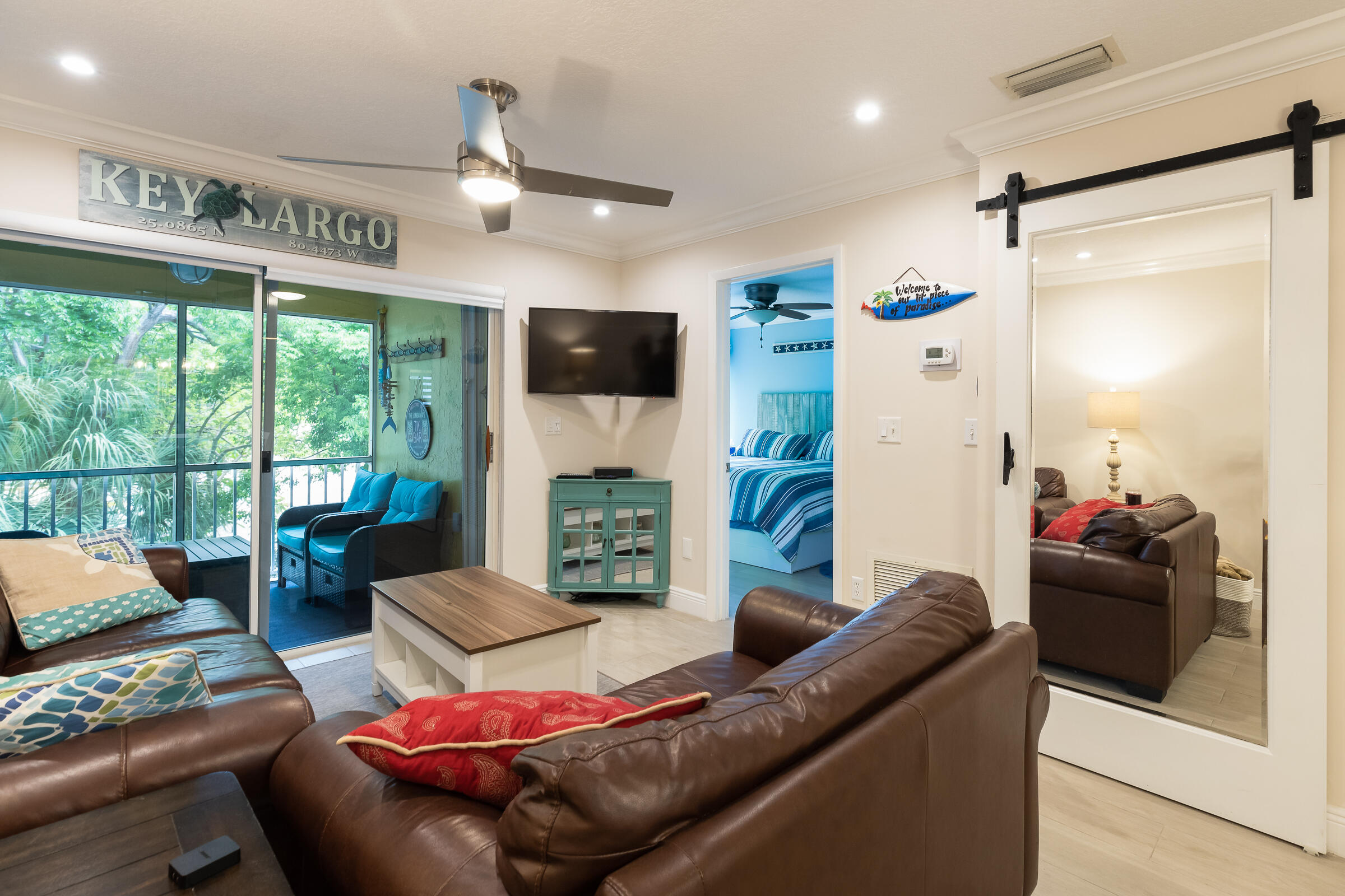 98222 Windward Avenue Key Largo, FL 33037 - Photo 15 of 41 a living room with furniture and a flat screen tv