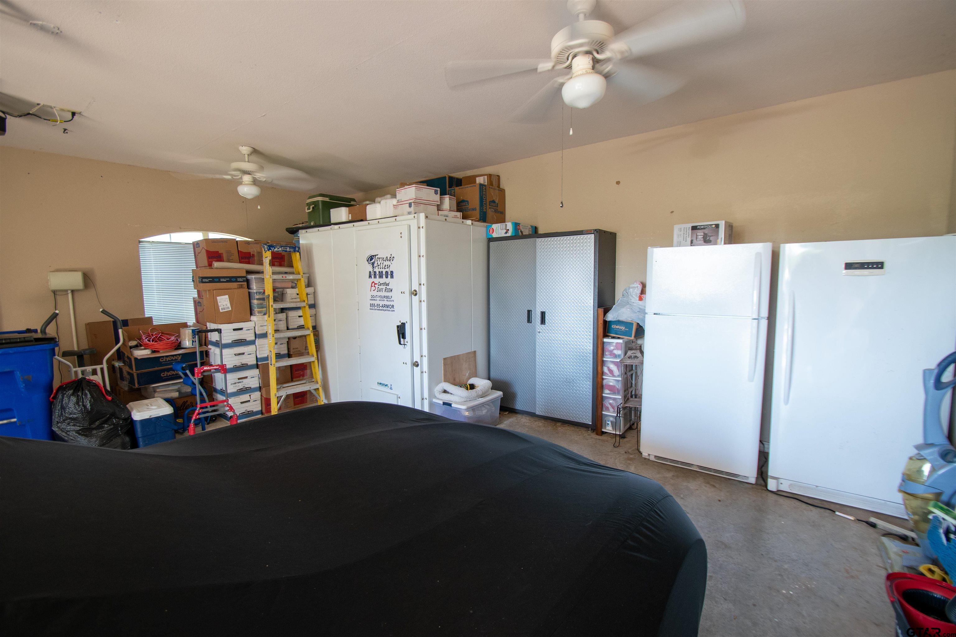 23120 Saddle Ridge Court Lindale, TX 75771 - Photo 28 of 34 a bedroom with bed and a large mirror