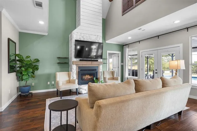 a living room with furniture a fireplace and a flat screen tv