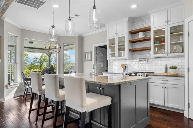 a large kitchen with a table and chairs