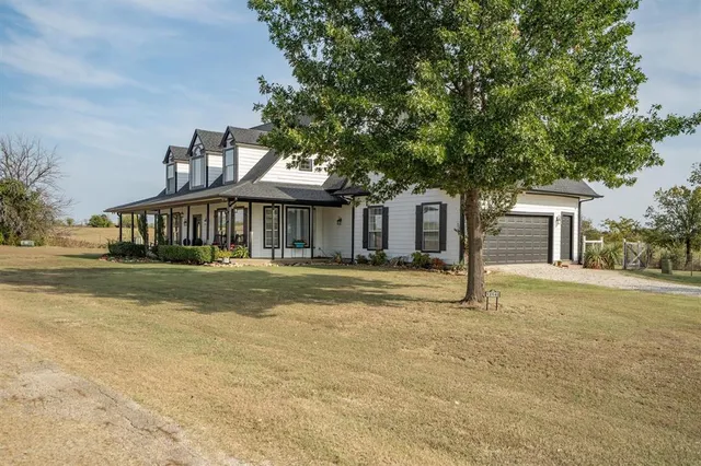 a view of house with outdoor space and shower