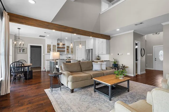 a living room with furniture a rug and a table