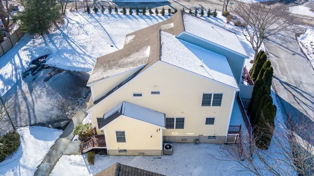 a view of a white house with a yard and sitting area