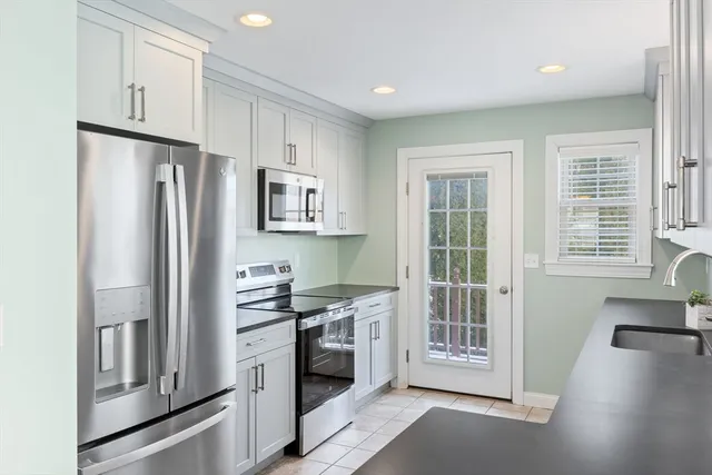 a kitchen with stainless steel appliances a refrigerator and a stove top oven
