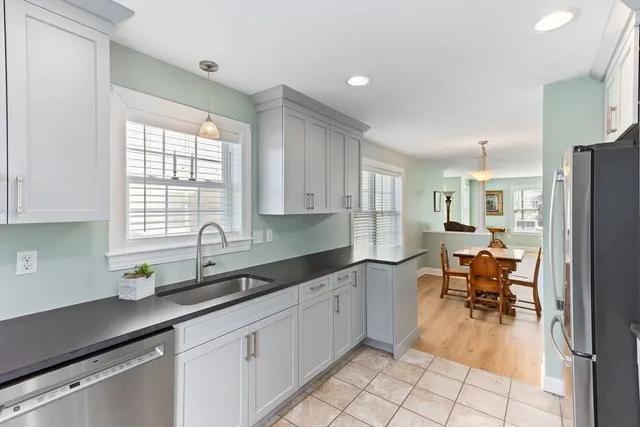 a kitchen with a sink dining table and chairs