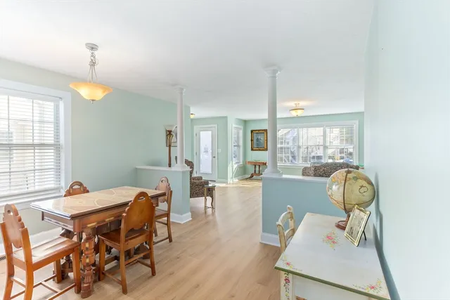 a view of a dining room with furniture wooden floor and chandelier