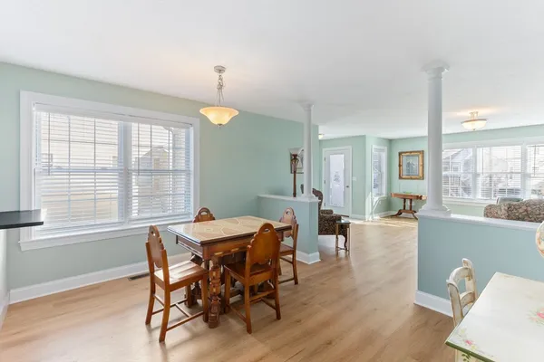 a view of a dining room with furniture and wooden floor