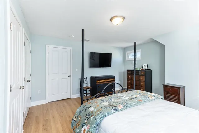 a bedroom with a bed and a flat screen tv