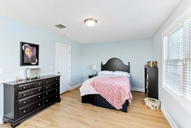 a bedroom with a bed and a dresser