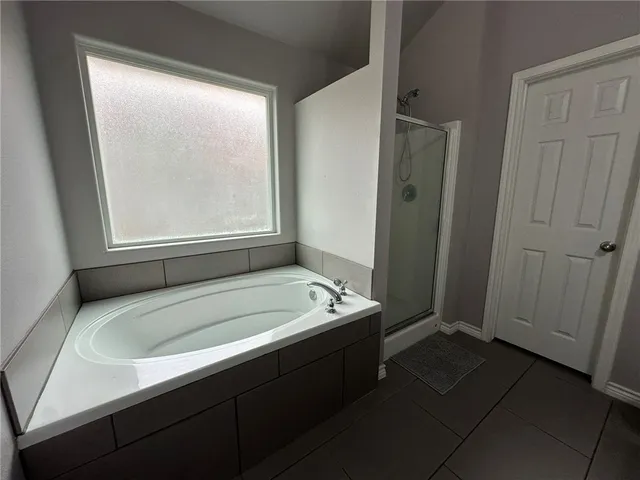 a bathroom with a tub sink and window