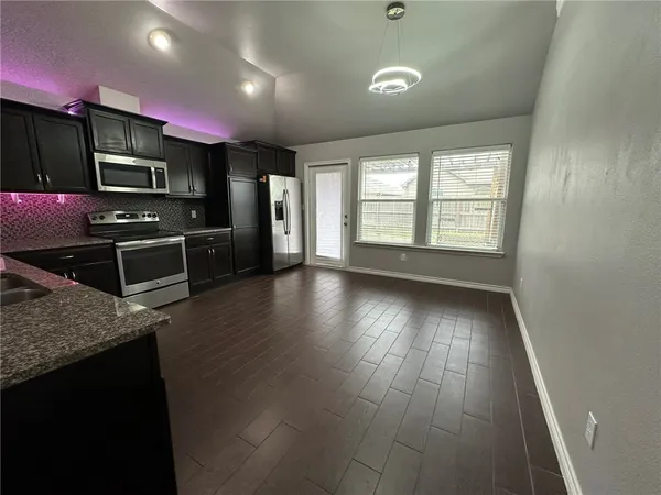 a view of a kitchen with microwave and stove