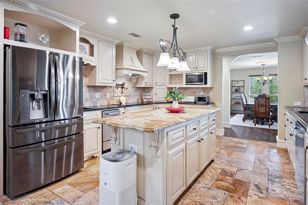 2309 Parker Road St. Paul, TX 75098 - Photo 11 of 40 a kitchen with stainless steel appliances a sink a stove a refrigerator and cabinets