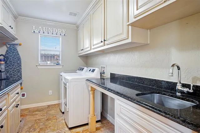 a utility room with sink dryer and washer