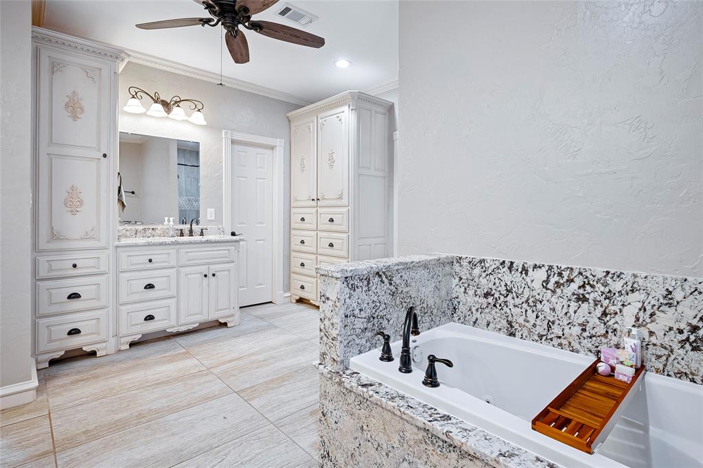 2309 Parker Road St. Paul, TX 75098 - Photo 19 of 40 a bathroom with a bathtub a sink and a mirror