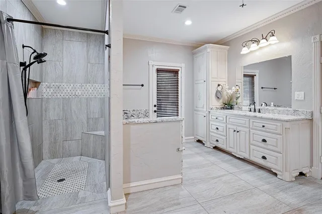 a bathroom with a granite countertop sink a mirror a shower and a bathtub
