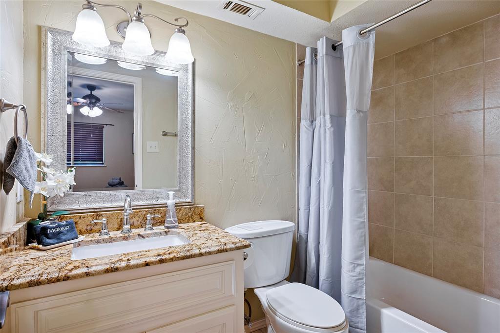 2309 Parker Road St. Paul, TX 75098 - Photo 30 of 40 a bathroom with a granite countertop sink mirror vanity and toilet