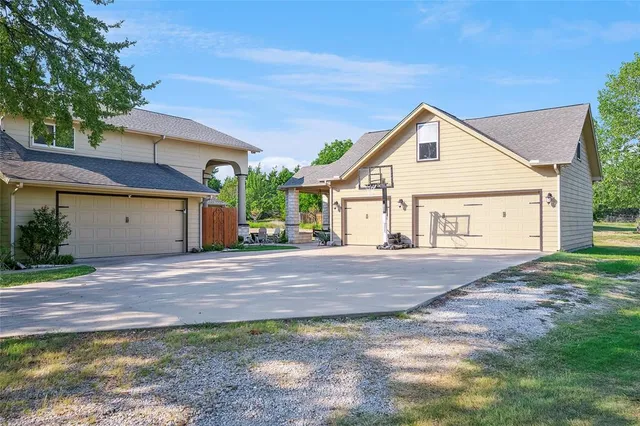 a view of a house with a yard and garage
