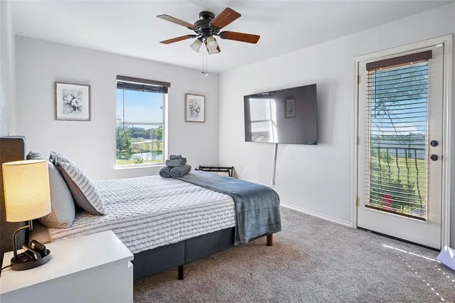a bedroom with a bed dresser and window