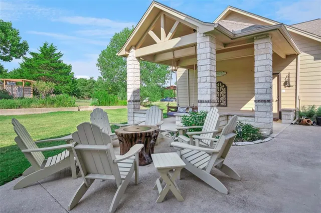 a view of a patio with a table and chairs