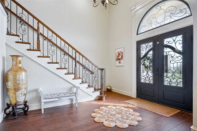 a view of entryway and hall with wooden floor