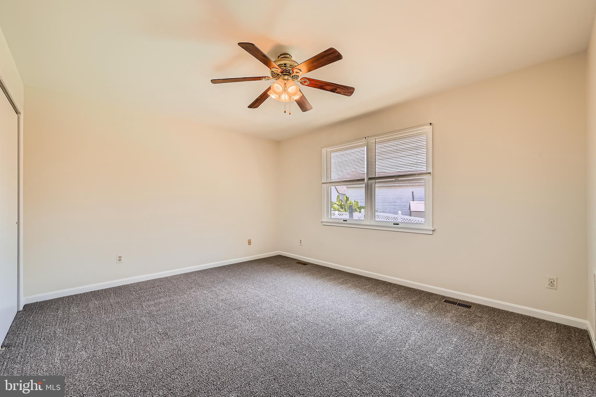 335 Poplar Road Baltimore, MD 21221 - Photo 12 of 34 an empty room with window and ceiling fan