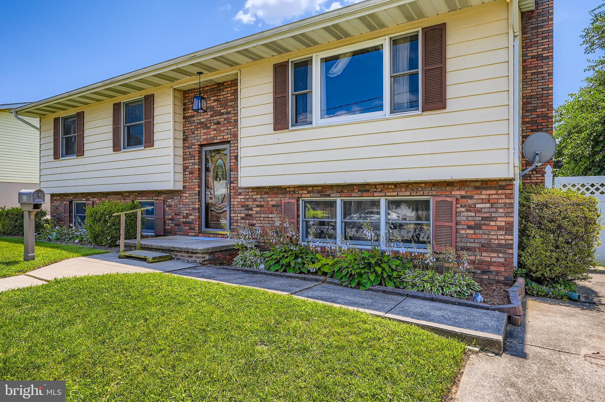 335 Poplar Road Baltimore, MD 21221 - Photo 2 of 34 a view of a brick house with a yard