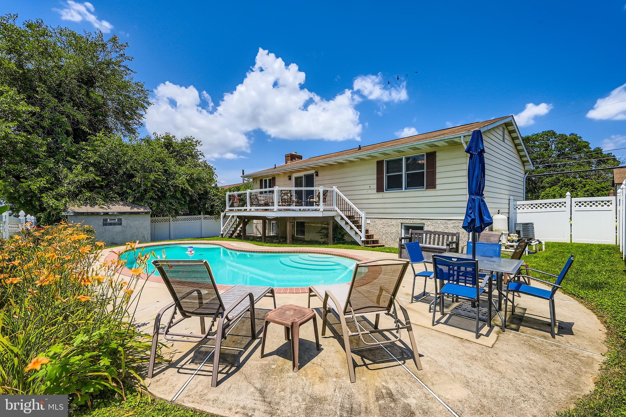 335 Poplar Road Baltimore, MD 21221 - Photo 31 of 34 a view of a patio with table and chairs potted plants with wooden floor