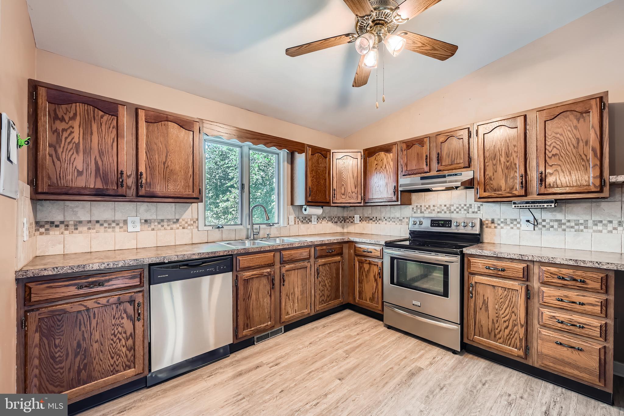 335 Poplar Road Baltimore, MD 21221 - Photo 10 of 34 a kitchen with stainless steel appliances granite countertop a stove cabinets and chandelier