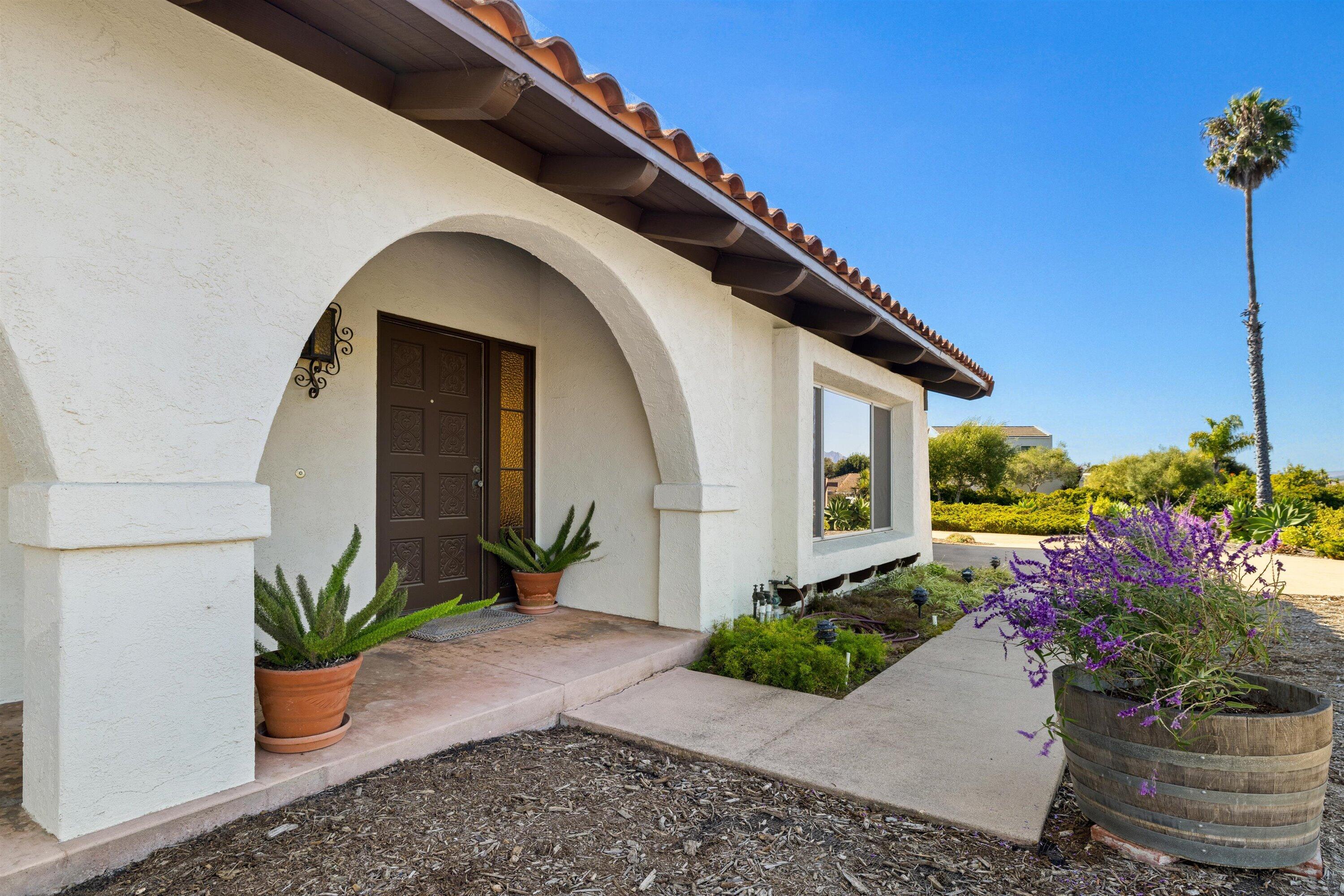 5187 Via Valverde Santa Barbara, CA 93111 - Photo 3 of 34 a potted plant sitting in front of a house