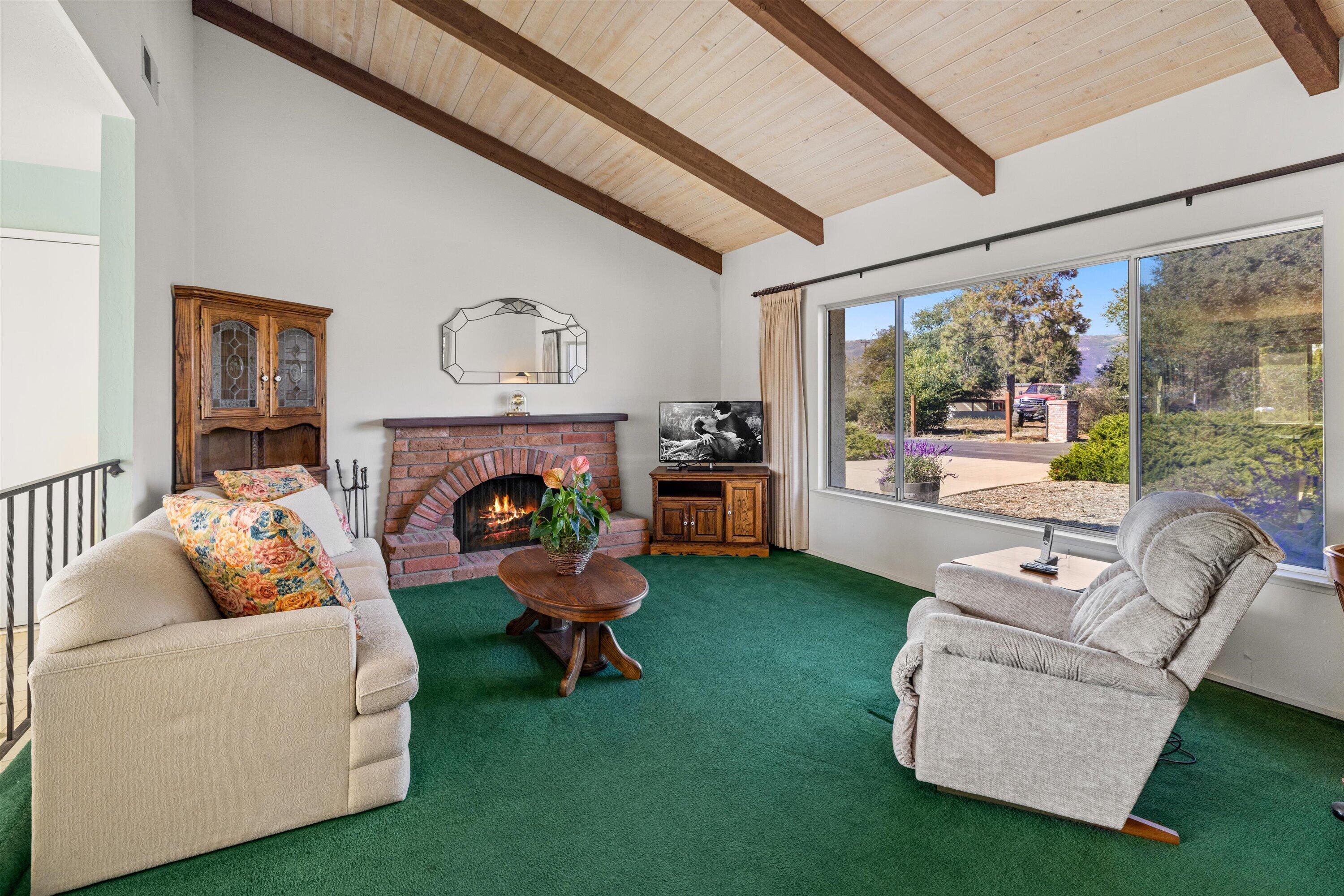 5187 Via Valverde Santa Barbara, CA 93111 - Photo 5 of 34 a living room with furniture and a fireplace