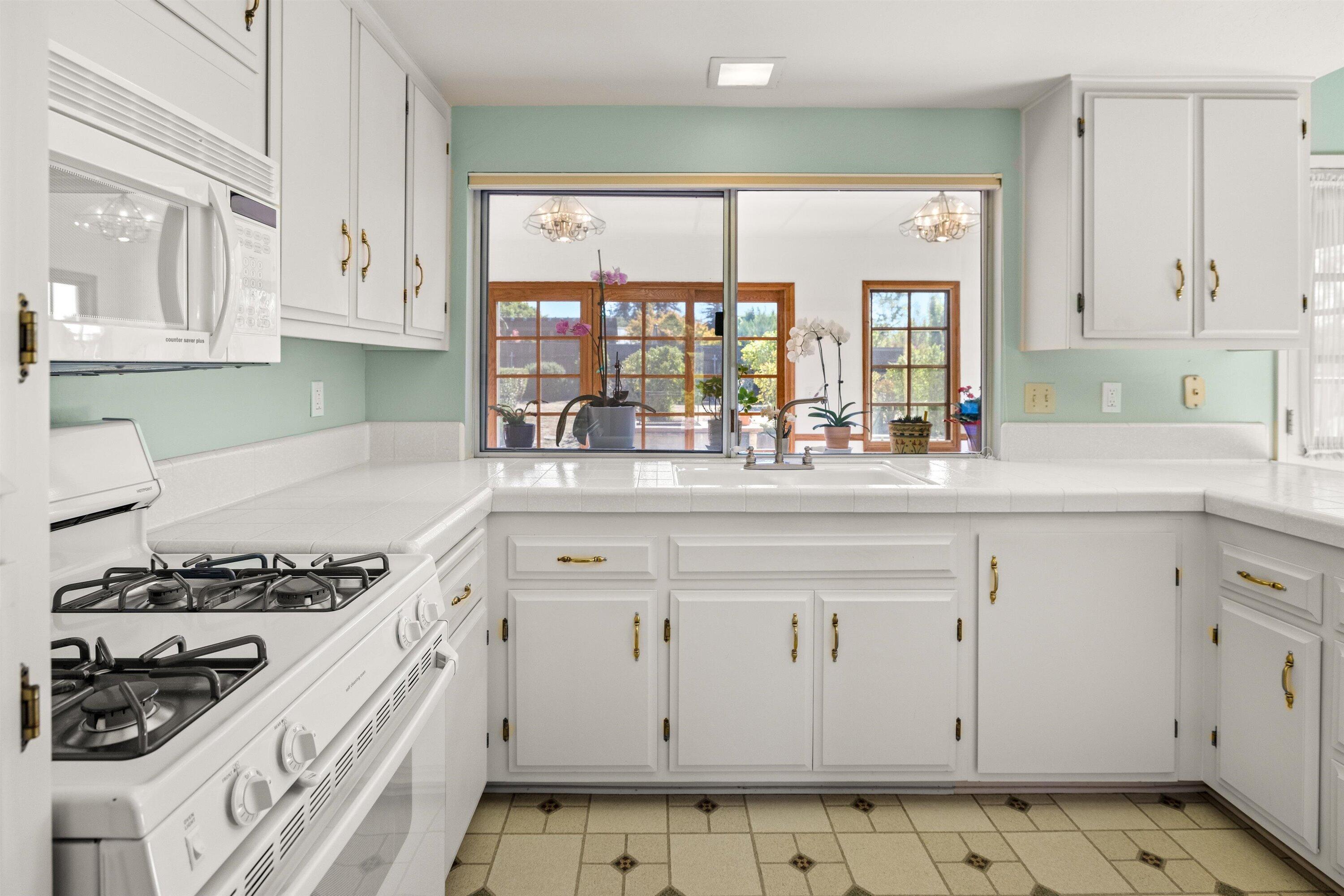 5187 Via Valverde Santa Barbara, CA 93111 - Photo 9 of 34 a kitchen with stainless steel appliances granite countertop a stove a sink and a granite counter tops