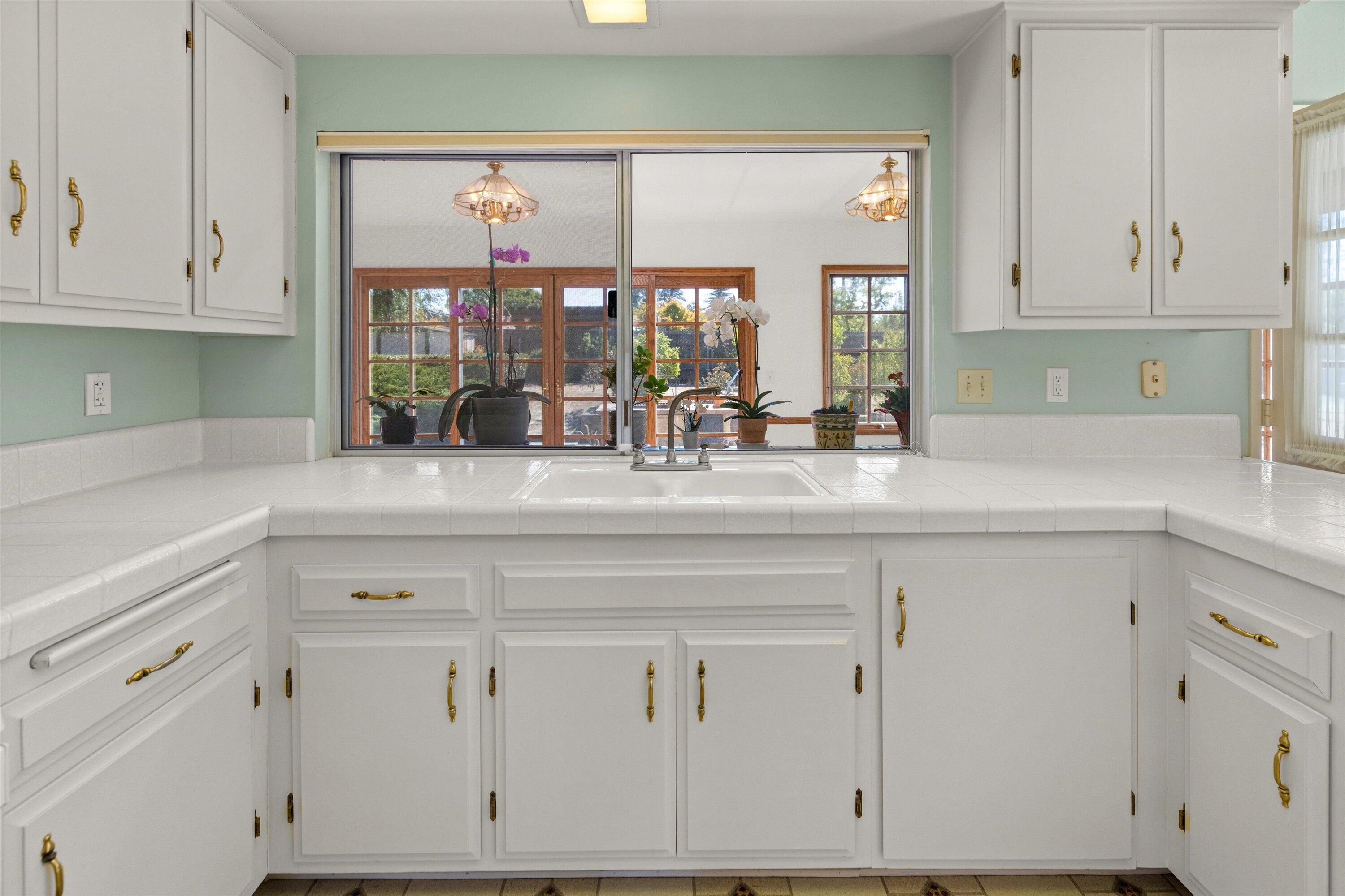 5187 Via Valverde Santa Barbara, CA 93111 - Photo 10 of 34 a kitchen with white cabinets and a large window