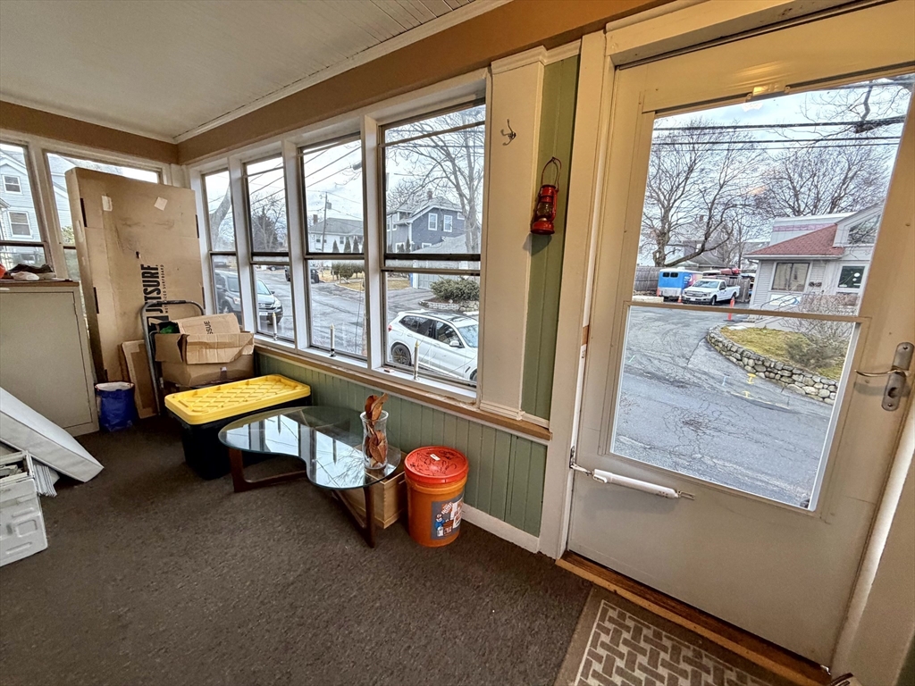 157 Riverview Avenue, Unit FURNISHED Waltham, MA 02453 - Photo 32 of 38 a living room with a table chair and front door