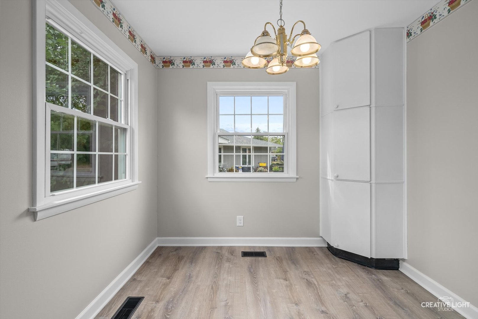 4 Pickford Road Montgomery, IL 60538 - Photo 8 of 17 an empty room with wooden floor cabinet and windows