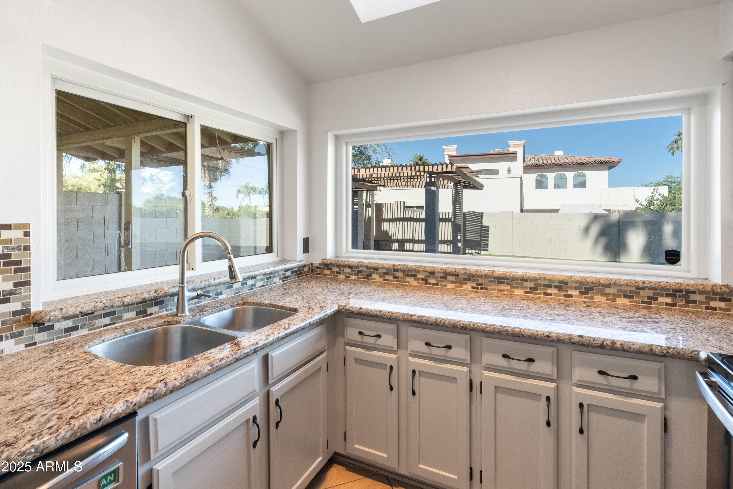 4652 East Piedmont Road Phoenix, AZ 85044 - Photo 11 of 30 a kitchen with granite countertop a sink and cabinets