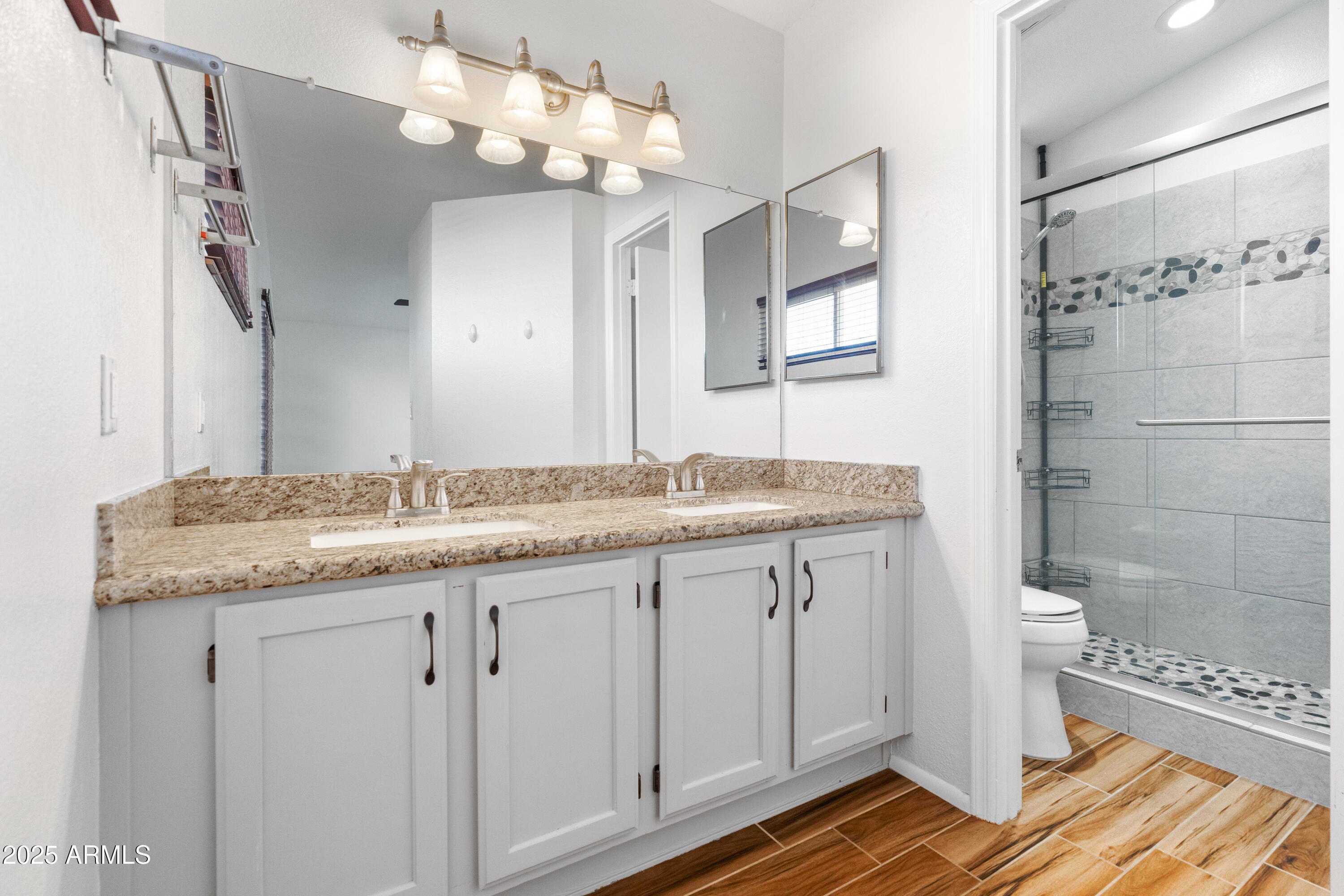 4652 East Piedmont Road Phoenix, AZ 85044 - Photo 15 of 30 a bathroom with a granite countertop sink a mirror and a shower